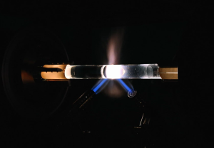 Photosensitive fiber preform rod with UV laser interference pattern for Bragg grating writing