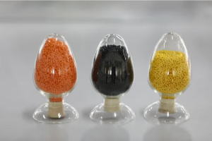 Close-up of black and natural polyethylene compound pellets used for cable jacketing