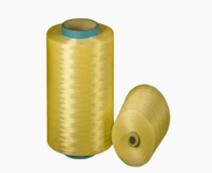 Close-up macro shot of continuous filament para-aramid yarn on a spool showing smooth, uniform fiber surface