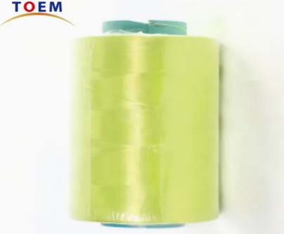 Close-up of golden-yellow para-aramid continuous filament yarn on spool