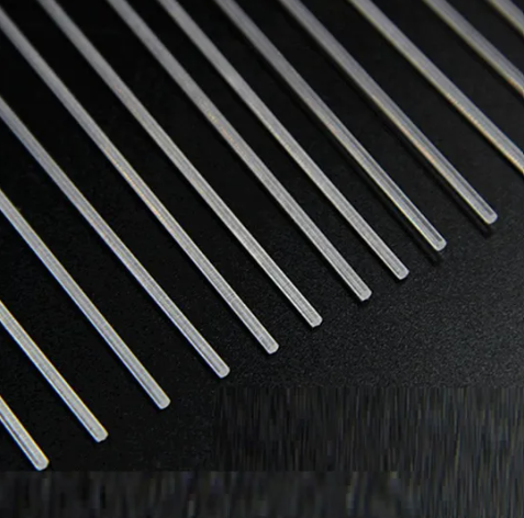 Flexible plastic optical fiber being bent around tight radius in industrial panel